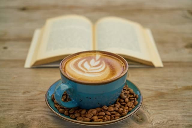 cup of coffee by a book