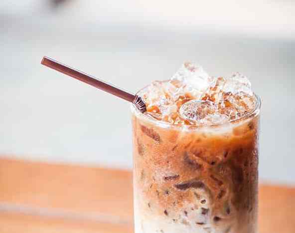 Glass-of-cold-coffee-latte-with-ice-cubes-up-close